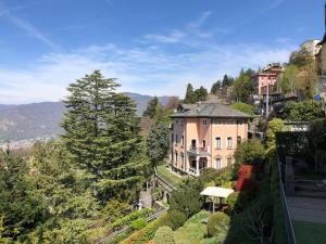 a large house on top of a hill with trees at IL NIDO DELLA FENICE in Brunate