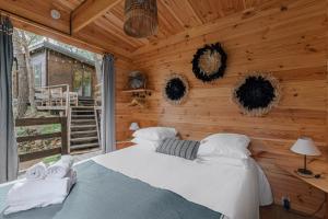 a bedroom with a bed in a log cabin at Les Cabanons de l'Ouille in Collioure +42 photos