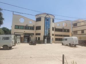 ein Gebäude mit zwei Lieferwagen davor in der Unterkunft Hotel complex europe in Guercif