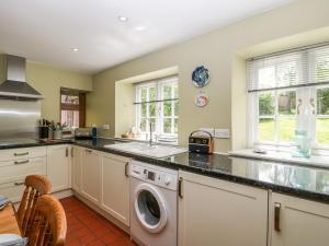 a kitchen with a washing machine and a sink at Redwood Cottage in Bristol