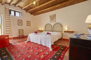 a bedroom with a bed and a red rug at Casale Monte Kronio by Wonderful Italy in Sciacca