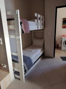 a couple of bunk beds in a room at Eleni Apartment in Perdika