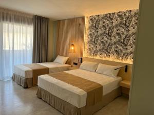 Postel nebo postele na pokoji v ubytování Hotel Noy