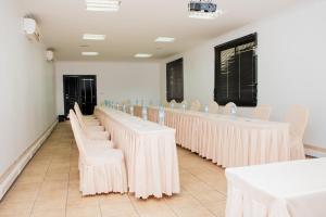 a row of tables and chairs in a room at Resotel in Maputo