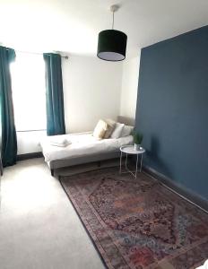 a bedroom with a bed and a table in a room at The Farrier in Cheltenham