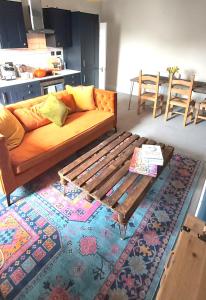a living room with a couch and a rug at The Farrier in Cheltenham