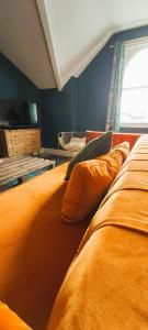 a bedroom with two beds and a tv on the wall at The Farrier in Cheltenham +3 photos