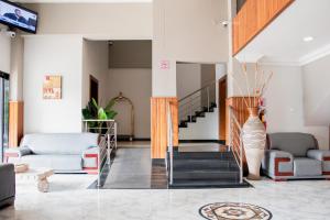 a living room with a staircase and a vase at Resotel in Maputo