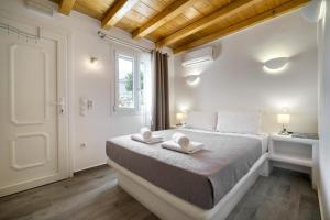 a bedroom with a bed with two towels on it at Anius Apartments in Mýkonos City