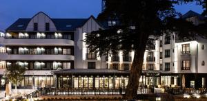 a large white building with a tree in front of it at Le Celtique & Spa in Carnac