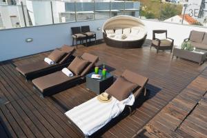 a deck with beds and a hot tub on a ship at Rooftop sea view with private swimming pool in Nazaré