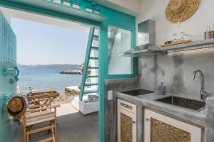 a kitchen with a view of the ocean at Turquoise Boathouse in Klima I in Klima