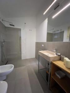 a bathroom with a sink and a toilet and a shower at Pedra Smeralda in Golfo Aranci