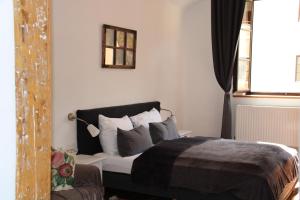 a bedroom with a bed with pillows and a window at Hotel im Stift Neuberg in Neuberg an der Mürz