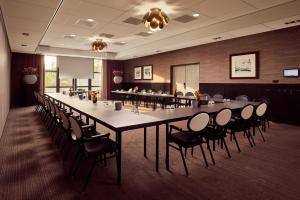 a large long table and chairs in a room at Van der Valk Drachten in Drachten