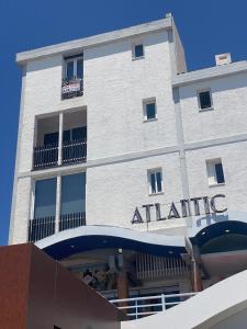 a white building with a atatlantic sign on it at Duplex Marina de Vilamoura in Vilamoura