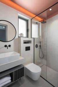 a bathroom with a sink and a toilet and a shower at Luxury Villa Ó - Dubrovnik in Orasac