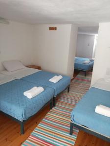 a room with two beds and a rug at VILLA SISSY in Agia Paraskevi +12 photos