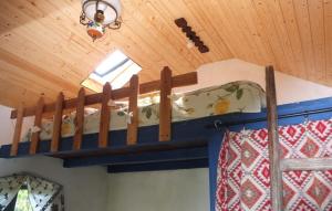 a bunk bed in a room with a wooden ceiling at Căsuța cu Miez - Treehouse in Vîlsăneşti