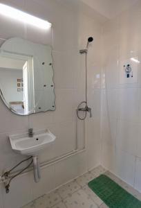 a white bathroom with a sink and a mirror at Casa Tatiana Eforie Nord in Eforie Nord +72 photos