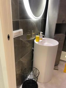 a bathroom with a white sink and a mirror at Palazzina Margò in Mola di Bari