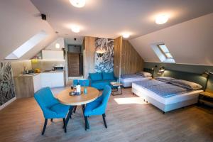 a room with a bed and a table and chairs at Apartamenty Camping Morski in Łeba