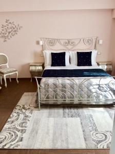 a bedroom with a large bed and a chair at Il Castellaccio Bed & Breakfast in Spello