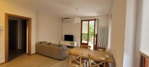 a living room with a table and a couch at Ca' de l'Achille in Torri del Benaco