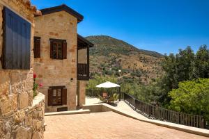 a house with a balcony with a view of a mountain at Sermar Villa in Episkopi Pafou