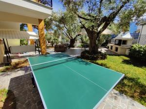 a pool table in the backyard of a house at Studios Apollon in Chrysi Ammoudia