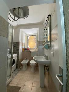 ナポリにあるNaples With Loveのバスルーム(洗面台、トイレ、鏡付)