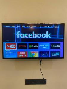 a flat screen television hanging on a wall at Makndak Roomstay in Arau