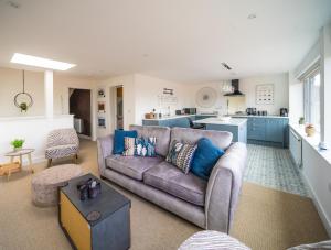 a living room with a couch and a kitchen at 'The View' Penthouse Apartment Number Four Lees Terrace in Holt +43 photos