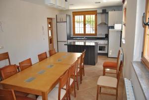 a kitchen with a long wooden table and chairs at Holiday home Casa las Margaritas in Salamanca