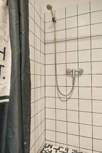a shower with a shower curtain in a bathroom at B3 Hostel Budapest in Budapest