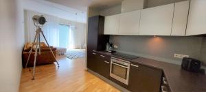 a kitchen with white cabinets and a counter top at Seedri Breakwater Residence with Private Parking in Pärnu