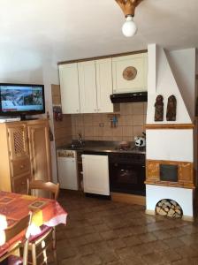 a kitchen with white cabinets and a stove top oven at Brunetti in Mazzin