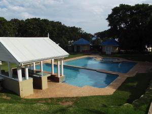 an overhead view of a swimming pool with a pavilion at 44 Montego Bay Caribbean Estates in Port Edward