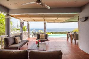 a patio with a view of the ocean at Villa Coral Breeze in Willemstad