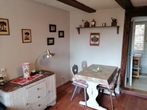 a room with a desk and a table with chairs at La Maison Vigneronne in Riquewihr