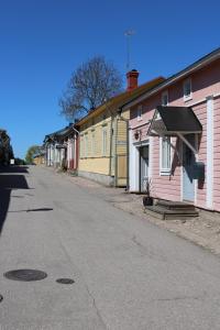 an empty street next to a row of buildings at Villa Hattu in Naantali