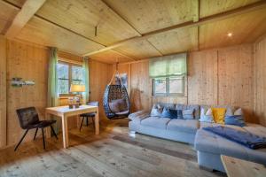 a living room with a couch and a table at Fewo Bergpanorama Obertalerhof in San Martino