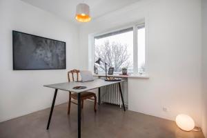 a white room with a table and a window at Luxury Apartment In Prime Location Ocean View in Reykjavík