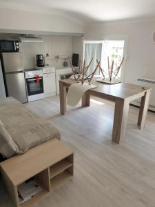 sala de estar con mesa y cocina en Appartement 62 m2 1er etage avec jardin au rdc, en Saint-Génis