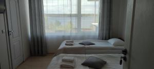 a hotel room with two beds and a window at Vijuandra in Zarasai