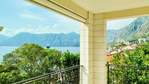 a balcony with a view of the water and mountains at Melodia del Mare in Kotor