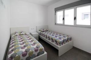 A bed or beds in a room at Townhouse Casa Champis