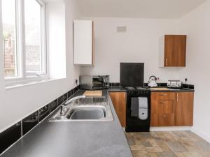 a kitchen with a sink and a stove at Butter Cross in Scarborough
