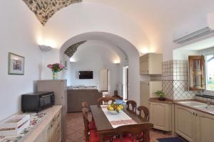 a kitchen with a table and a dining room at Amalfi Sky View in Scala