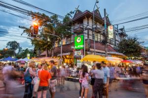 a crowd of people standing around a street market at Parasol Inn Chiang Mai Old City Hotel - SHA Plus in Chiang Mai